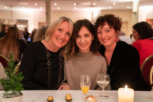 Freundinnen beim festlichen Anlass lachen zusammen bei Hahne Holding Veranstaltung, Winterfest, Networking, Geschäftsessen in der Eventlocation.